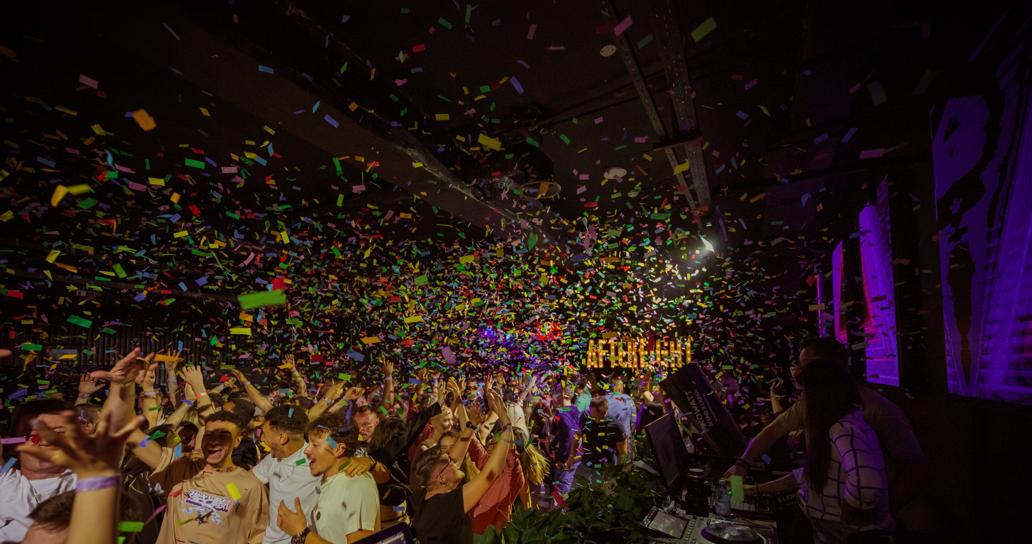 Crowd dancing under confetti at After Eight night club in Cluj-Napoca